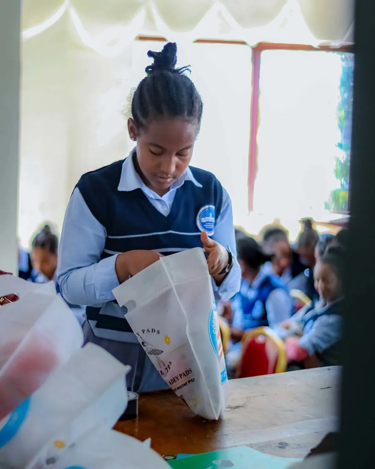 A schoolgirl opens her dignity kit